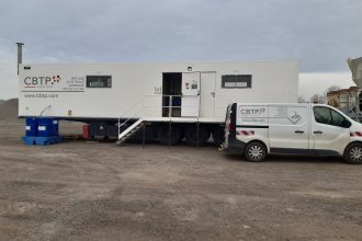 Laboratoire mobile CBTP pour tests de matériaux de chaussée, stationné sur zone de travaux.